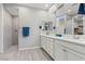 Bathroom with double sink vanity and walk-in shower with gray-scale tiling at 10416 Skye Arroyo Ave, Las Vegas, NV 89166