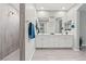 Spacious bathroom featuring dual vanity, walk-in shower, and tile flooring at 10416 Skye Arroyo Ave, Las Vegas, NV 89166