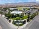 Aerial view of Skye Canyon Park, featuring a pool, playground, and lush landscaping at 10416 Skye Arroyo Ave, Las Vegas, NV 89166