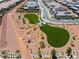 Aerial view of a neighborhood dog park with green spaces, walking paths and shaded areas at 10416 Skye Arroyo Ave, Las Vegas, NV 89166