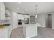 Modern kitchen with stainless steel appliances, large island, white cabinets, and stylish pendant lighting at 10416 Skye Arroyo Ave, Las Vegas, NV 89166