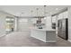 Spacious kitchen features stainless appliances, a center island, tile floors and sliding doors to the patio at 10416 Skye Arroyo Ave, Las Vegas, NV 89166