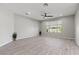 Spacious living room with tile floors, a ceiling fan, a window, and neutral paint at 10416 Skye Arroyo Ave, Las Vegas, NV 89166