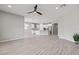 Open concept living area featuring tile floors and a view of the modern kitchen at 10416 Skye Arroyo Ave, Las Vegas, NV 89166