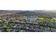 Panoramic aerial shot capturing a vibrant suburban community, complete with nearby recreational facilities and mountainous backdrop at 11082 Sospel Pl, Las Vegas, NV 89141