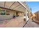 Spacious backyard patio with a pergola providing shade and a brick-lined pathway at 11082 Sospel Pl, Las Vegas, NV 89141