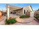 Charming backyard featuring a covered patio and landscaped areas with brick accents at 11082 Sospel Pl, Las Vegas, NV 89141