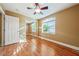 Cozy bedroom with hardwood flooring, a mirrored closet, and a large window letting in natural light at 11082 Sospel Pl, Las Vegas, NV 89141