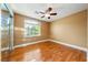 Bedroom featuring a ceiling fan, a large window, and hardwood floors at 11082 Sospel Pl, Las Vegas, NV 89141