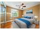 Cozy bedroom featuring a ceiling fan, a large window, and neutral decor at 11082 Sospel Pl, Las Vegas, NV 89141