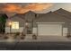 Charming single-story home with a two-car garage and landscaped front yard under a lovely sunset sky at 11082 Sospel Pl, Las Vegas, NV 89141