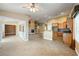 Open-concept living room with tile floors, tan walls, a fireplace, and a breakfast bar connecting to the kitchen at 11082 Sospel Pl, Las Vegas, NV 89141