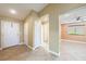 Bright living space with neutral paint, tile flooring, a ceiling fan, and views of the front and side yards at 11082 Sospel Pl, Las Vegas, NV 89141