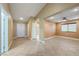 Open living area with neutral paint, tile flooring, a ceiling fan, and a window view of the backyard at 11082 Sospel Pl, Las Vegas, NV 89141