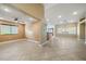 Open floor plan featuring tile flooring, ceiling fans, and large windows, perfect for comfortable living and entertaining at 11082 Sospel Pl, Las Vegas, NV 89141