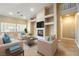 Bright living room featuring a fireplace, comfortable seating, and built-in shelving for a modern and inviting space at 11082 Sospel Pl, Las Vegas, NV 89141