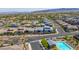 Wide aerial view of a desert neighborhood with a community pool, well-maintained streets and a mountain range backdrop at 11672 Barga Ct, Las Vegas, NV 89138