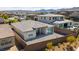 Aerial view of a backyard with brick fencing and patio space, complemented by desert landscaping and neighboring homes at 11672 Barga Ct, Las Vegas, NV 89138