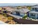 Aerial view of a backyard featuring brick fencing, patio space, desert landscaping and neighborhood surroundings at 11672 Barga Ct, Las Vegas, NV 89138