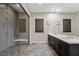 Stylish bathroom featuring a walk-in shower with bench, a double vanity, and updated fixtures at 11672 Barga Ct, Las Vegas, NV 89138