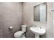 This half-bath features modern tilework and beautiful fixtures at 11672 Barga Ct, Las Vegas, NV 89138
