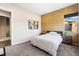 This bedroom is well-lit and features an accent wall at 11672 Barga Ct, Las Vegas, NV 89138