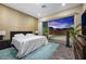 Beautiful bedroom with a large window offering plenty of natural light and a view of the sunset at 11672 Barga Ct, Las Vegas, NV 89138