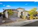 Attractive single-story home with stone accents, desert landscaping and a brick driveway, exuding modern elegance and charm at 11672 Barga Ct, Las Vegas, NV 89138