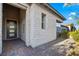 Home's stone facade and covered entryway lead into a modern living space, complemented by tasteful landscaping at 11672 Barga Ct, Las Vegas, NV 89138