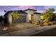Contemporary home with a brick driveway, desert landscaping, and a two-car garage, offering modern curb appeal at 11672 Barga Ct, Las Vegas, NV 89138