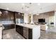 Modern open-concept kitchen and living area with a long white quartz island, dark cabinets, and stainless steel appliances at 11672 Barga Ct, Las Vegas, NV 89138
