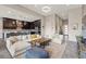 Open-concept living room with a modern kitchen, a breakfast bar, and comfortable seating for seamless entertaining at 11672 Barga Ct, Las Vegas, NV 89138
