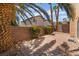 Cozy backyard patio with brick pavers, brick wall fencing, and mature landscaping at 1220 Padre Serra Ln, Las Vegas, NV 89134