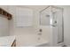 Bright bathroom featuring a shower over tub with sliding glass doors and a window at 1220 Padre Serra Ln, Las Vegas, NV 89134