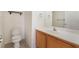 Half bath with a wooden vanity, white countertop, and a neutral color scheme at 1220 Padre Serra Ln, Las Vegas, NV 89134