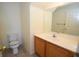 Neutral bathroom features a vanity with a white countertop and a standard toilet at 1220 Padre Serra Ln, Las Vegas, NV 89134