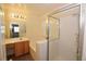 Bright bathroom with shower stall, large soaking tub, and wood vanity at 1220 Padre Serra Ln, Las Vegas, NV 89134