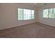 Bedroom featuring carpet, a ceiling fan, and natural light from large windows at 1220 Padre Serra Ln, Las Vegas, NV 89134