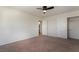 Bedroom featuring neutral carpet, ceiling fan, and closet with sliding doors at 1220 Padre Serra Ln, Las Vegas, NV 89134