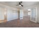 Spacious bedroom featuring neutral carpet, ceiling fan, and glass panel french doors at 1220 Padre Serra Ln, Las Vegas, NV 89134