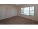 Carpeted bedroom with natural light, a fan, and a closet at 1220 Padre Serra Ln, Las Vegas, NV 89134