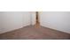 Bedroom features carpet floors, neutral walls, a window, and double doors at 1220 Padre Serra Ln, Las Vegas, NV 89134