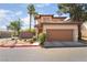 Attractive two-story home featuring a tile roof, lush landscaping, and a convenient two-car garage at 1220 Padre Serra Ln, Las Vegas, NV 89134