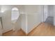 Upstairs hallway with wood floors and natural light from a window at 1220 Padre Serra Ln, Las Vegas, NV 89134