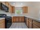 Bright kitchen featuring wood cabinets, tile countertops, and modern black appliances at 1220 Padre Serra Ln, Las Vegas, NV 89134