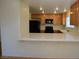 Open kitchen design featuring wood cabinets and a breakfast bar for casual dining at 1220 Padre Serra Ln, Las Vegas, NV 89134