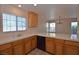 Kitchen boasts white countertops, wood cabinets, and modern appliances, flowing into the dining area at 1220 Padre Serra Ln, Las Vegas, NV 89134
