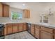 Charming kitchen with tile countertops, wood cabinets and stainless steel dishwasher at 1220 Padre Serra Ln, Las Vegas, NV 89134