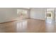 Open living area featuring hardwood floors, a large window, and access to the backyard at 1220 Padre Serra Ln, Las Vegas, NV 89134