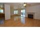 Bright, open living area with wood floors, fireplace, and access to kitchen and backyard through sliding doors at 1220 Padre Serra Ln, Las Vegas, NV 89134